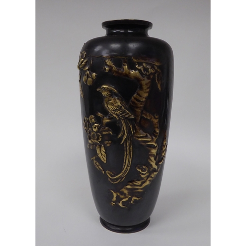 7 - An early 20thC Japanese cast bronze vase of tapered baluster form, decorated with an applied exotic ... 