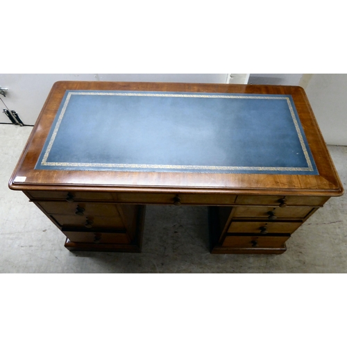 70 - A late Victorian mahogany nine drawer, twin pedestal desk, on a plinth  28