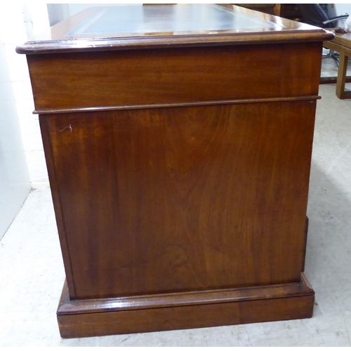 70 - A late Victorian mahogany nine drawer, twin pedestal desk, on a plinth  28