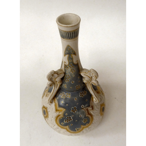 71 - A late 19thC Doulton Lambeth Carrara stoneware bottle vase with applied handles, decorated in tones ... 