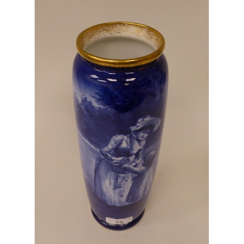 75 - An early 20thC Royal Doulton china cylindrical vase, decorated in blue and white with a woman and ch... 