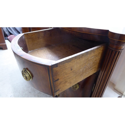 76 - An Edwardian string inlaid mahogany, one piece breakfront kneehole sideboard with an arrangement of ... 