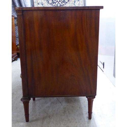 76 - An Edwardian string inlaid mahogany, one piece breakfront kneehole sideboard with an arrangement of ... 