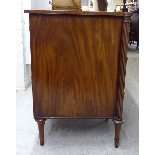 76 - An Edwardian string inlaid mahogany, one piece breakfront kneehole sideboard with an arrangement of ... 