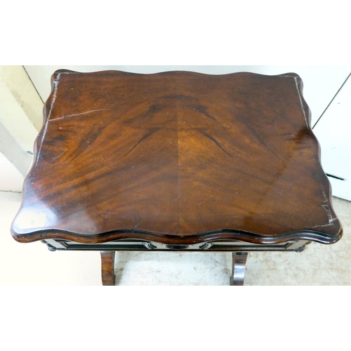 8 - A late Victorian mahogany work table with a serpentine outlined, hinged lid, over reeded pillar supp... 