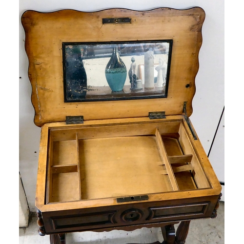 8 - A late Victorian mahogany work table with a serpentine outlined, hinged lid, over reeded pillar supp... 