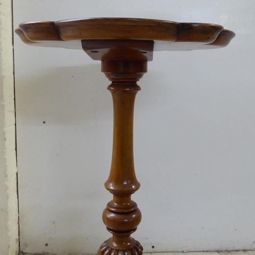 80 - A late Victorian walnut and mahogany pedestal table, raised on a tripod base  25.5