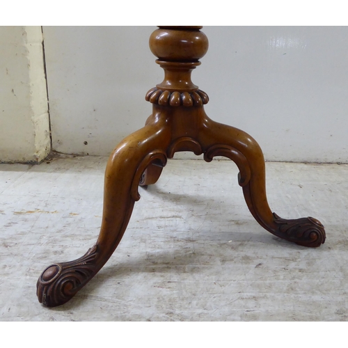 80 - A late Victorian walnut and mahogany pedestal table, raised on a tripod base  25.5