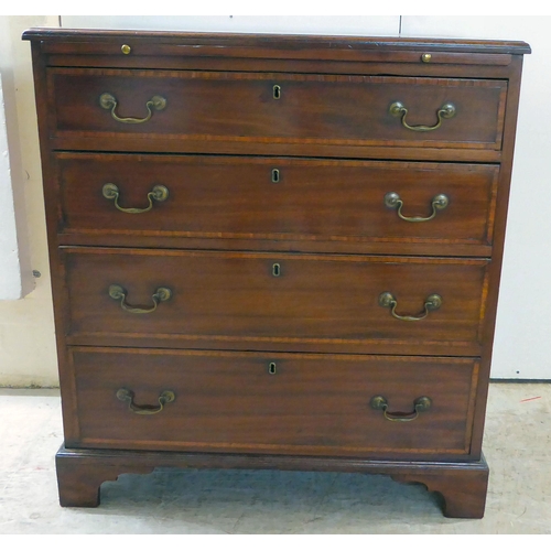 84 - A George III mahogany bachelor's chest with a brushing slide, over four graduated drawers, raised on... 