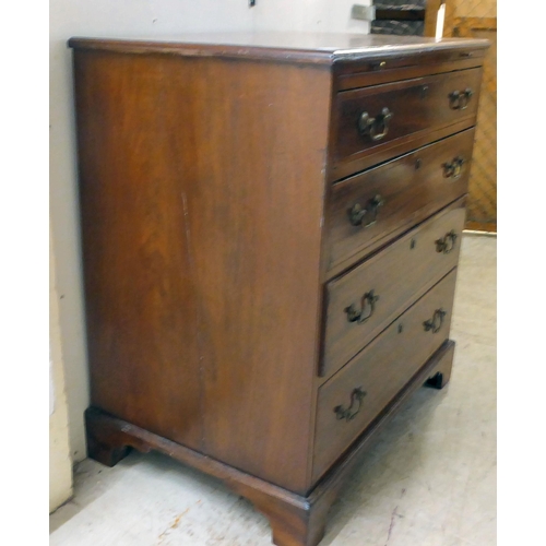 84 - A George III mahogany bachelor's chest with a brushing slide, over four graduated drawers, raised on... 