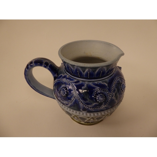 85 - A late Victorian Doulton Lambeth stoneware jug of spherical form, decorated in tones of blue and gre... 