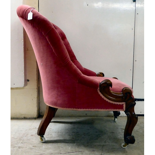 87 - A late Victorian walnut framed and red fabric upholstered nursing chair, raised on carved cabriole l... 