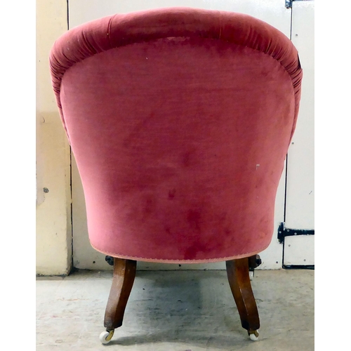 87 - A late Victorian walnut framed and red fabric upholstered nursing chair, raised on carved cabriole l... 