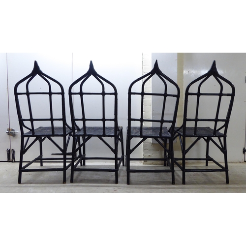 90 - A set of four 20thC black painted, bamboo effect and caned bound conservatory chairs