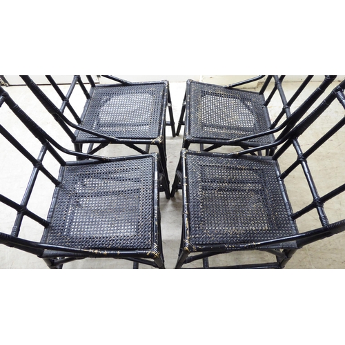 90 - A set of four 20thC black painted, bamboo effect and caned bound conservatory chairs