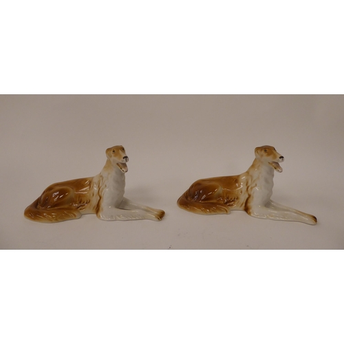 91 - A pair of Royal Dux porcelain models, seated brown and white Borzoi Wolfhounds  bearing impressed &a... 