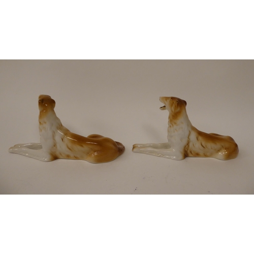 91 - A pair of Royal Dux porcelain models, seated brown and white Borzoi Wolfhounds  bearing impressed &a... 