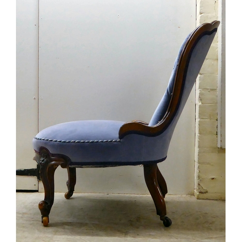 92 - A late Victorian mahogany showwood framed and part-button upholstered nursing chair, raised on carve... 