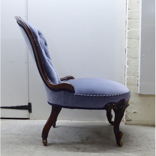 92 - A late Victorian mahogany showwood framed and part-button upholstered nursing chair, raised on carve... 