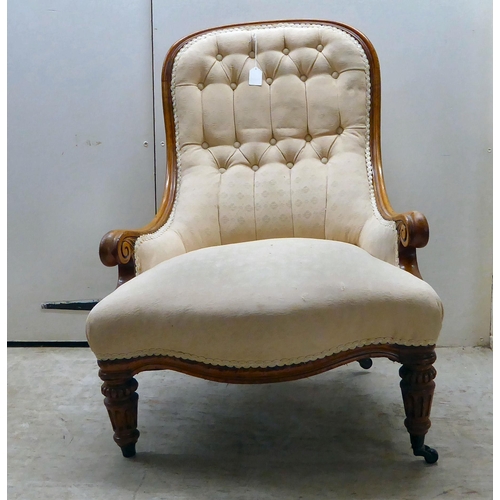 95 - A late Victorian mahogany showwood framed and part-button upholstered nursing chair, raised on carve... 