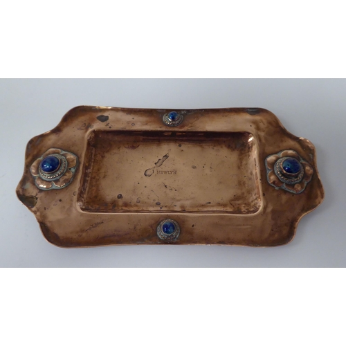 98 - An early 20thC Arts & Crafts copper pin tray, decorated with coloured beads  impressed Newl... 