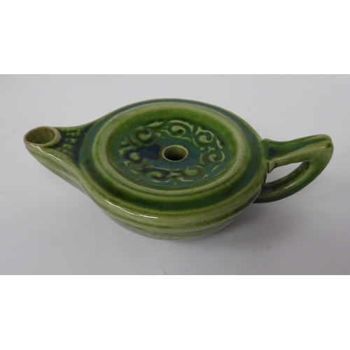 99 - A Liberty of London green glazed and scroll decorated stoneware oil lamp base with a carrying handle... 