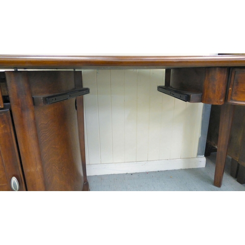 398 - A modern mahogany finished kidney shaped desk with twin pedestal, one with a drawer, the other, a dr... 