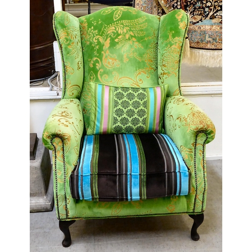 414 - A modern green and gold coloured fabric upholstered wingback library chair with multi-colours stripe... 