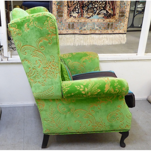 414 - A modern green and gold coloured fabric upholstered wingback library chair with multi-colours stripe... 