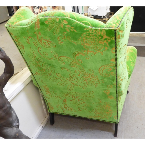 414 - A modern green and gold coloured fabric upholstered wingback library chair with multi-colours stripe... 