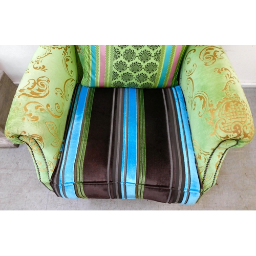 414 - A modern green and gold coloured fabric upholstered wingback library chair with multi-colours stripe... 