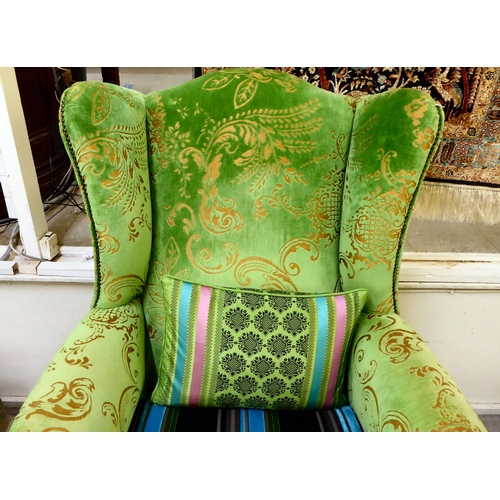 414 - A modern green and gold coloured fabric upholstered wingback library chair with multi-colours stripe... 