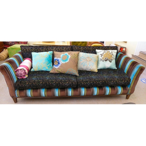 415 - A modern multi-coloured fabric upholstered four person settee with various scatter cushions  96... 