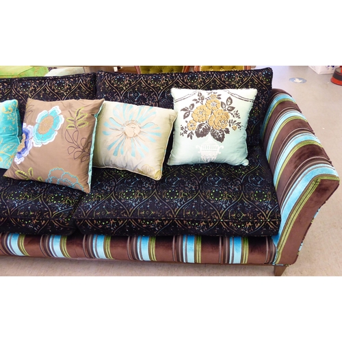 415 - A modern multi-coloured fabric upholstered four person settee with various scatter cushions  96... 