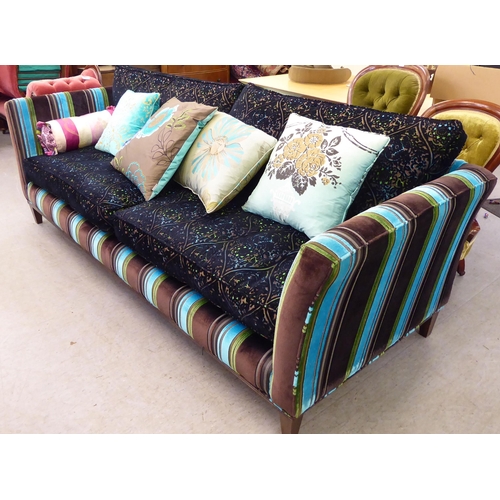 415 - A modern multi-coloured fabric upholstered four person settee with various scatter cushions  96... 