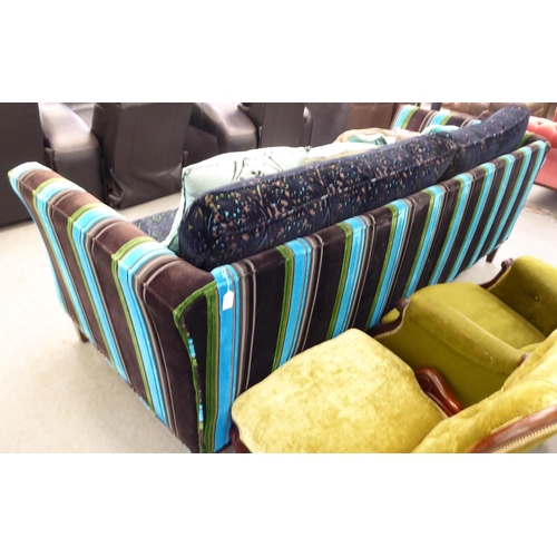 415 - A modern multi-coloured fabric upholstered four person settee with various scatter cushions  96... 