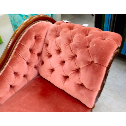 62 - A late Victorian mahogany framed chaise lounge, upholstered in a maroon coloured fabric, raised on t... 