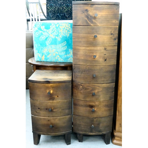 411 - A modern stained pine bowfront, pillar design, seven drawer dressing chest  55