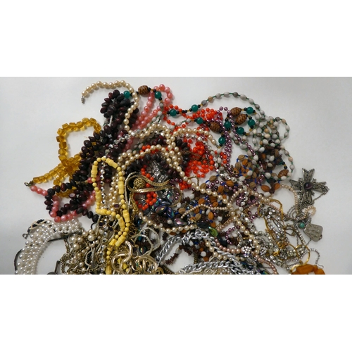 22 - Costume jewellery: to include simulated amber coloured bead necklaces; assorted pendants; brooches; ... 