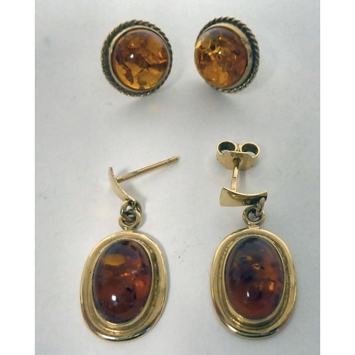 276 - A pair of 14ct gold, amber set earrings; and a similar pair of 9ct gold