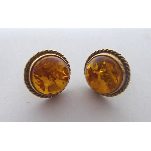 276 - A pair of 14ct gold, amber set earrings; and a similar pair of 9ct gold