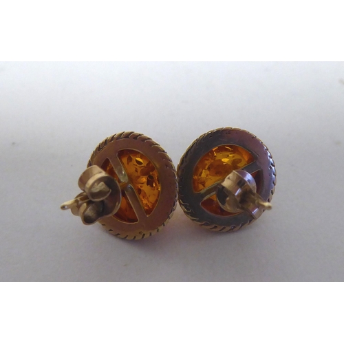 276 - A pair of 14ct gold, amber set earrings; and a similar pair of 9ct gold