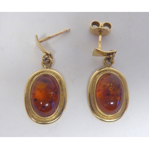 276 - A pair of 14ct gold, amber set earrings; and a similar pair of 9ct gold