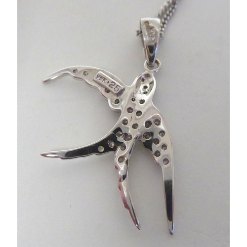 278 - An 18ct white gold, diamond set, swallow pendant, on a fine neckchain and ring bolt clasp