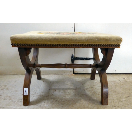 282 - A late Victorian mahogany framed stool with a tapestry upholstered top, raised on arched legs