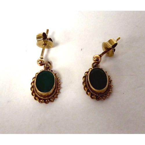 288 - A pair of 9ct gold, oval, emerald set pendant earrings