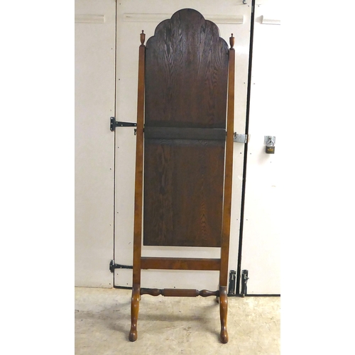 289 - A 1930s mahogany framed cheval mirror with a plain plate, raised on splayed legs with pad feet ... 