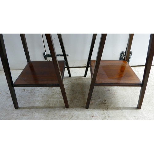 292 - A pair of Edwardian mahogany two-tier occasional/hall tables, raised on square legs  27