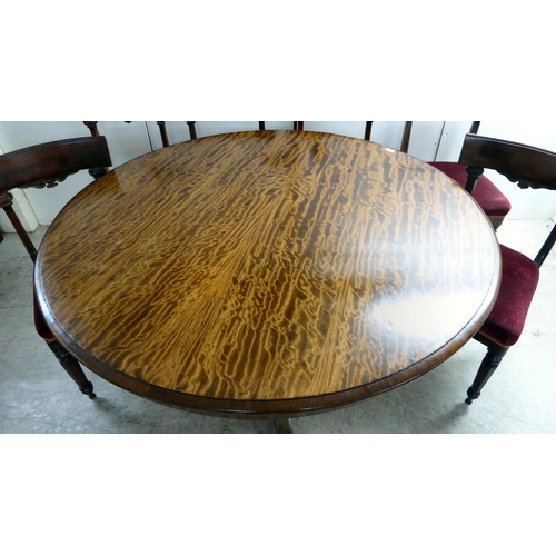 294 - An early Victorian mahogany breakfast table with a tip-top, over a turned column and splayed legs  2... 