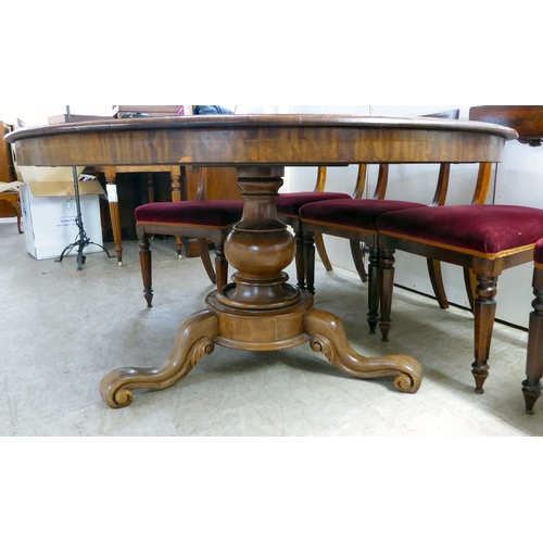 294 - An early Victorian mahogany breakfast table with a tip-top, over a turned column and splayed legs  2... 